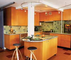 
The apartment's original kitchen was gutted, and two walls were removed to bring in natural light and marry it with the living space. The wheatboard cabinets were handcrafted by Amish cabinetmakers from Pennsylvania. The Stave Stools by Witt Design are available from http://www.Vivavi.com.
